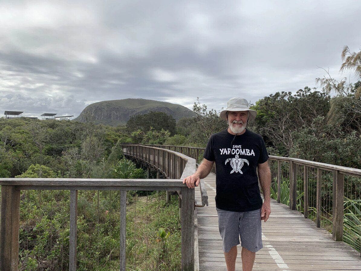 A Save Yaroomba supporter standing on a coastal boardwalk