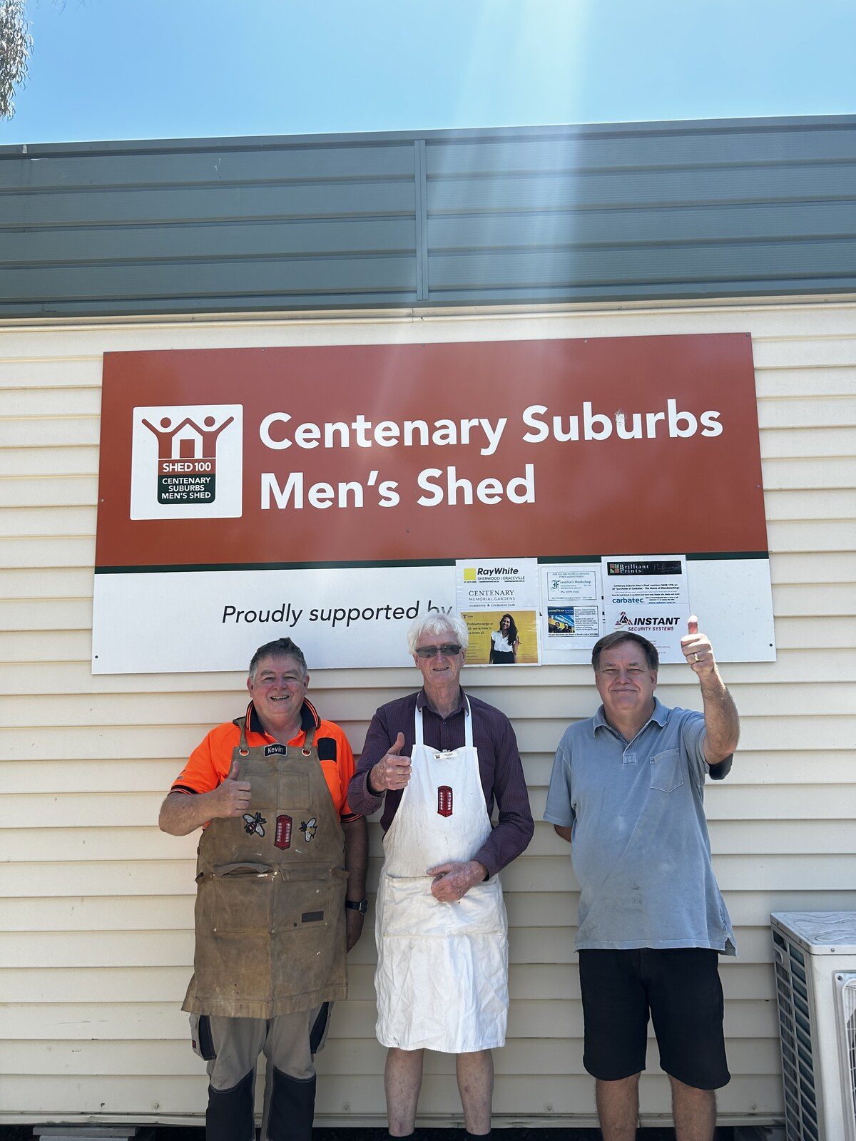 Members of the Centenary Suburbs Men's Shed standing outside their workshop